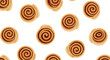 © Rakhi - A delicious and sweet seamless pattern of freshly baked cinnamon rolls scattered randomly on a clean white background.