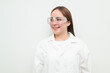 © Ranta Images - Portrait of Asian female research scientist against white background smiling and thinking