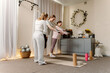 © m-art - Three women engage in a group workout in a bright studio filled with natural light. They use fitness equipment while enjoying the supportive atmosphere.