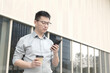 © zhu difeng - asian businessman using smart phone outdoor