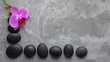 © olegganko - Arrangement of Stones and an Orchid Flower on a Gray Surface During Daylight