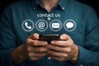 © MstTasmiya - Businessman using smartphone with contact us icon or customer support hotline people connect for contact us concept.