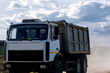 © Eugeniusz - Blue sky with cumulus clouds, truck driving on dirt road