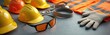 © Vadym - Collection of safety gear including hard hats glasses gloves, high visibility vest laid out on hard surface. Personal protective equipment for construction site work ensures worker safety, accident