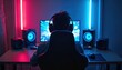 © Pete - Young person wears headphones playing computer game. Neon lights glow in room near speakers. Person uses mouse and keyboard, focused on screen with colorful graphics.