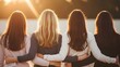 © MDEMDADULLAH - Four women with arms around each other at sunset