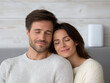 © DDargon - Happy couple cuddling at home loving relationship cozy mood peaceful expression gentle smile closed eyes casual sweater soft light indoor portrait intimacy