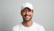 © Viktor - Smiling man wearing white t-shirt and baseball cap isolated on grey background. Young guy with beard looks happy and confident. Pro portrait for work or business.