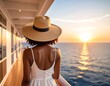 © Batrey - Woman with a sunhat watches the sunset over the ocean