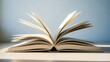 © Bayu Tri Nugroho - Open book with pages flipping in a well-lit environment perfect for reading studying or educational purposes in a modern setting