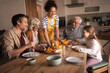 © Jelena - Family Gathering At Home: Warm Dinner With Grandparents, Parents, And Child