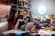 © Davor - Adult women smiling and collaborating on phone in fashion studio