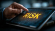 © Ala - Businessman uses tablet to analyze risk in modern office setting