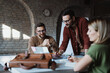 © Novak - Small creative business team working together in a cozy modern office. Collaborative startup environment