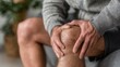 © tongpatong - A man at home with a hurting knee injury