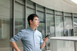 © zhu difeng - asian man using smart phone in office