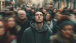 © VictorCanalesStudio - Young man standing calm with closed eyes and headphones in a blurred crowd