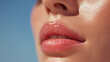 © Marut - Glossy lips and glowing cheek close up with natural moisture on smooth skin under soft light, highlighting healthy and hydrated facial features in serene setting