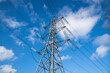 © Jon - Electricity Pylon Towering Against Clear Blue Sky