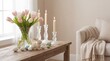© Eugen - Easter arrangement with pink tulips in vase, white candles, painted eggs and bunny figure on wooden table. Spring holiday decoration concept in soft pastel colors for cozy home interior.