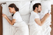 © Prostock-studio - Relationship Crisis. Indifferent Married Couple Texting On Phones Lying Back To Back In Bed At Home, Above View. Indifference In Marriage, Marital Problems Concept