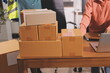 © Phanphen - Startup SME small business entrepreneur of freelance Asian woman wearing apron using laptop and box to receive and review orders online to prepare to pack sell to customers, online sme business ideas.