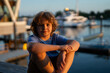© Volodymyr - Child portrait near quiet marina. Child portrait with peaceful mood. Child portrait in warm evening light. Child portrait showing thoughtful emotion.