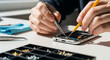 © ahmadiliandy - Precision Tech Repair: A technician's skillful hands meticulously repairing a mobile phone, demonstrating the intricate process of fixing electronic devices with precision.