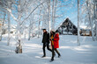 © Halfpoint - Couple walking together on romantic winter date in snowy nature