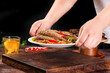 © QuangVinh - Chef Serving Delicious Fried Fish with Red Peppers and Green Onions
