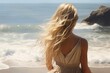 © juliars - Woman standing on the beach, observing the vast ocean and waves