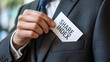 © Ali - A businessman holding a share index card in his suit pocket