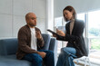 © BJ Day Stock - Asian man consulting with asian woman psychologist at mental health clinic. psychologist taking notes and talking with male patient with depression.