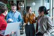 © BusinessClass by W61 - Business team collaborating in modern coworking office while smiling
