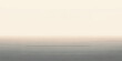 © MDNUR - A beautiful sunrise reflects over the calm ocean waves as misty morning fog drifts across the horizon under a light blue summer sky