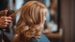 © Jhati - A woman with long blonde hair getting a styling treatment at a salon with a hair dryer