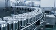 © FikriVisuals - Numerous aluminum beverage cans moving in a continuous line along a factory conveyor belt during automated production.