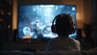 © Екатерина Чумаченко - A young gamer immersed in an exciting video game, illuminated by the soft glow of the screen in a dimly lit room, headphones on, focused.