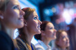 © Photoenthusiast82 - Close up of a Group of female executives attend corporate event. Audience watches projection screen with business performance presentation . Professionals learn in classroom setting. Teamwork