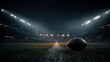 © ZHAOQINGHUA - American football under bright stadium lights at night with blurred crowd for sports marketing and event promotion