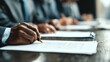 © Madon Sapi - Business people signing document at meeting