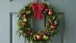 © HAMIDUL ISLAM  - Festive Red Bow Christmas Wreath with Holly and Ornaments on Door image photo