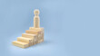 © OrangRobot - Single wooden figure standing on stacked blocks representing personal growth, achievement, career progress, and self development concept.