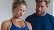 © fotogurme - A focused Caucasian woman and supportive Caucasian man in workout apparel embrace fitness harmony, celebrating Global Wellness Day