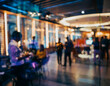 © Maria Polunina - Soft blurred after-work office party with warm lights, colleagues socializing and relaxed corporate atmosphere. Ideal for team-building, workplace culture and informal professional events.