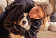 © mariamontoyart - Woman hugging old border collie dog demonstrating love