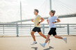 © muse studio - Running on a bridge during the day in the city