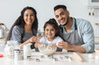 © Prostock-studio - Adorable middle eastern family father, mother and little daughter making cookies at home, adding eggs into dough, smiling at camera, enjoying time together, kitchen interior. Family lifetime concept