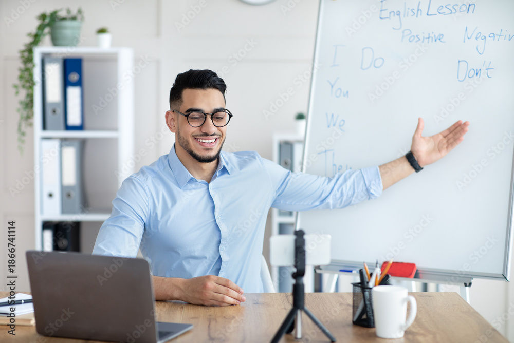 E learning concept. Positive Arab male teacher giving online English ...