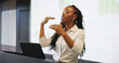 © Flash25/peopleimages.com - Presentation, talking or black woman with laptop at podium, company stats or performance data review. Business seminar, pc or employee with info analysis, explain chart or graph for growth discussion